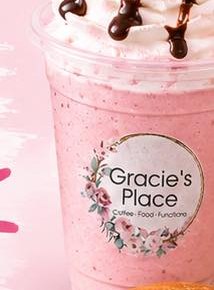 A strawberry milkshake topped with whipped cream and chocolate drizzle